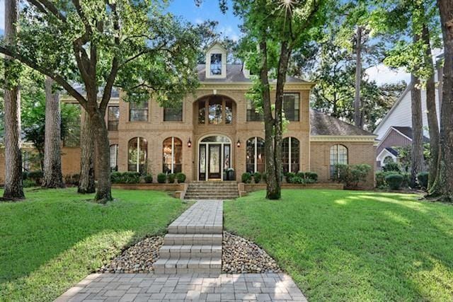 1714 Chestnut Grove Ln, Houston, TX 77345 - view of front of house with a front yard and brick siding