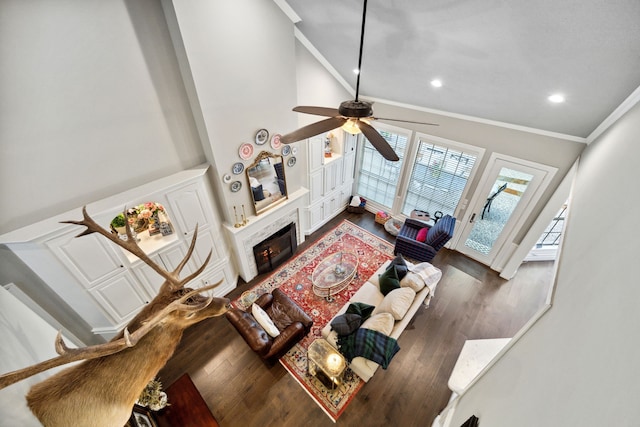1714 Chestnut Grove Ln, Houston, TX 77345 - living room with ornamental molding, dark wood-style flooring, a ceiling fan, recessed lighting, and a fireplace with flush hearth