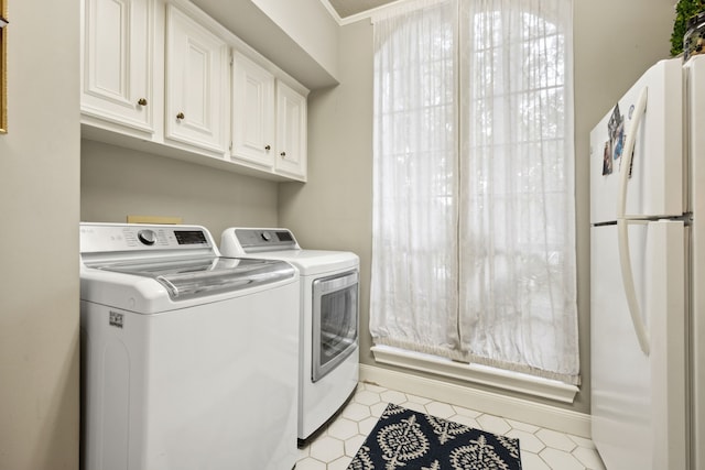 1714 Chestnut Grove Ln, Houston, TX 77345 - laundry area featuring washing machine and clothes dryer and light tile patterned floors