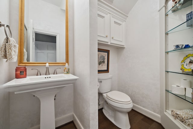 1714 Chestnut Grove Ln, Houston, TX 77345 - bathroom featuring toilet, wood finished floors, and baseboards