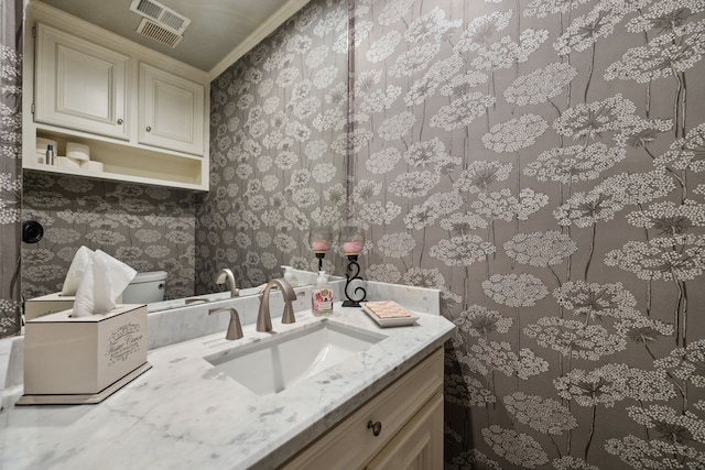1714 Chestnut Grove Ln, Houston, TX 77345 - half bathroom with wallpapered walls, vanity, crown molding, and toilet