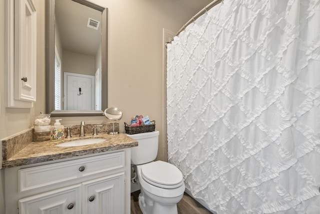 1714 Chestnut Grove Ln, Houston, TX 77345 - full bathroom with toilet, vanity, and wood finished floors