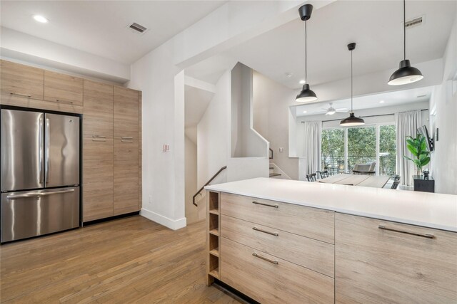 2809 St Emanuel St, Houston, TX 77004 - kitchen featuring freestanding refrigerator, light wood finished floors, baseboards, light countertops, and modern cabinets