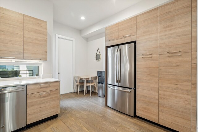 2809 St Emanuel St, Houston, TX 77004 - kitchen featuring appliances with stainless steel finishes, light brown cabinets, light wood-style flooring, modern cabinets, and recessed lighting