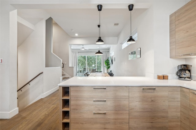 2809 St Emanuel St, Houston, TX 77004 - kitchen with modern cabinets, wood finished floors, a peninsula, and light brown cabinetry