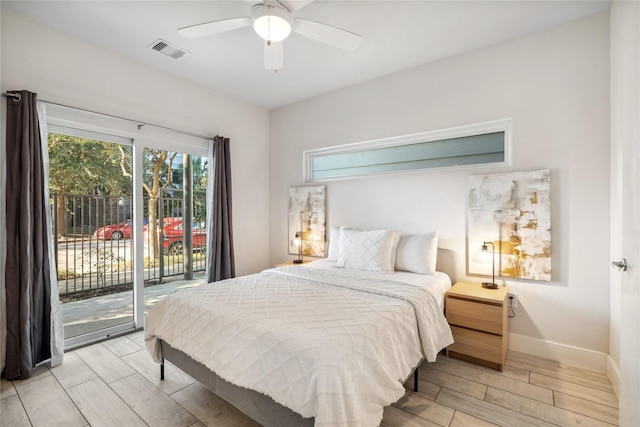 2809 St Emanuel St, Houston, TX 77004 - bedroom featuring access to exterior, multiple windows, wood tiled floors, and baseboards