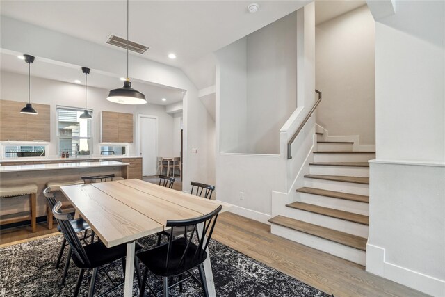 2809 St Emanuel St, Houston, TX 77004 - dining area with light wood-style flooring, stairway, recessed lighting, and baseboards