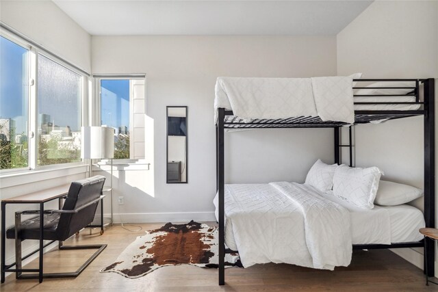 2809 St Emanuel St, Houston, TX 77004 - bedroom featuring wood finished floors, baseboards, and a city view
