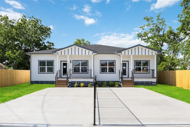 4825 Pederson St A/B, Unit A/B Houston, TX 77033 - view of front of house featuring board and batten siding, roof with shingles, and covered porch