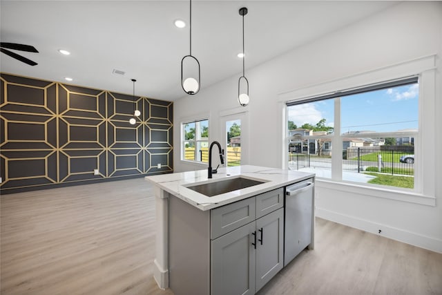 4825 Pederson St A/B, Unit A/B Houston, TX 77033 - kitchen featuring dishwasher, a sink, gray cabinetry, light wood-style flooring, and light stone countertops