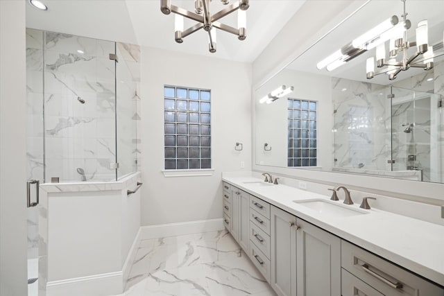 183 Timber Mill St, The Woodlands, TX 77380 - bathroom featuring a chandelier, marble finish flooring, baseboards, a marble finish shower, and double vanity