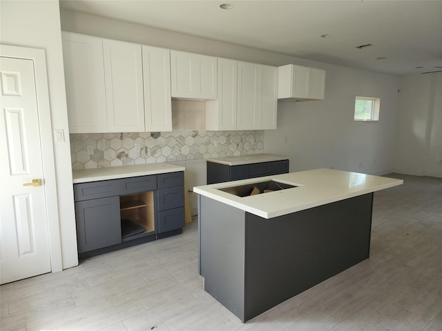 8208/8210 Knox St, Houston, TX 77088 - kitchen with decorative backsplash, light wood-type flooring, and white cabinets