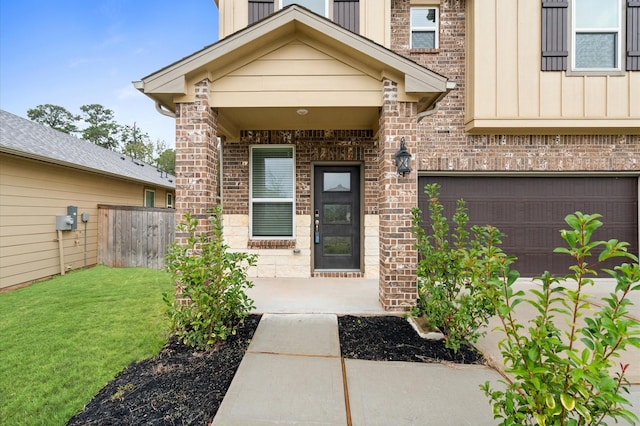 7051 Silverleaf Oak St, Conroe, TX 77304 - view of exterior entry featuring brick siding, a garage, and board and batten siding