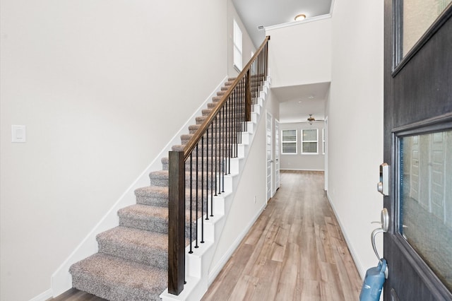 7051 Silverleaf Oak St, Conroe, TX 77304 - entryway with stairs, light wood-type flooring, ceiling fan, a high ceiling, and baseboards