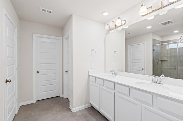 7051 Silverleaf Oak St, Conroe, TX 77304 - bathroom featuring baseboards, double vanity, a shower stall, recessed lighting, and tile patterned flooring
