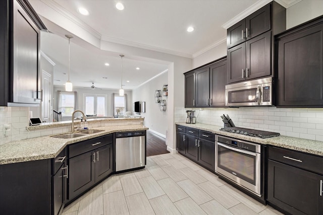 3715 Oakroc Grv, Houston, TX 77018 - kitchen featuring appliances with stainless steel finishes, a sink, ornamental molding, tasteful backsplash, and light stone counters