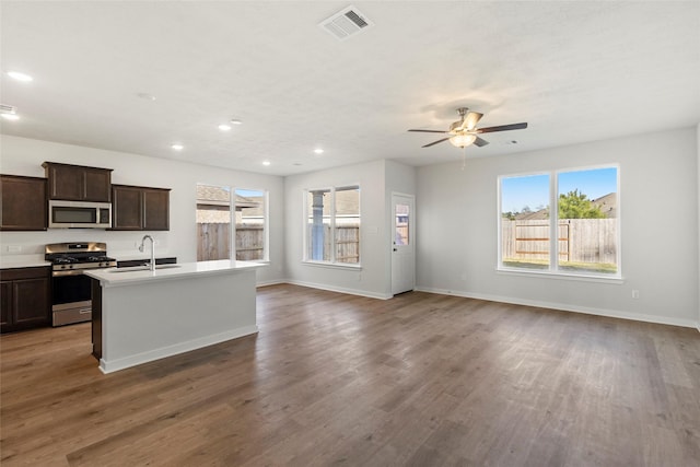 1505 Mirador Dr, Conroe, TX 77301 - kitchen with appliances with stainless steel finishes, open floor plan, wood finished floors, ceiling fan, and recessed lighting