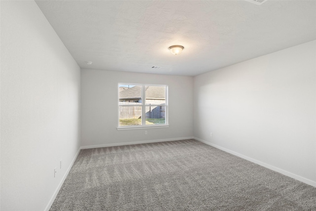 1505 Mirador Dr, Conroe, TX 77301 - empty room with carpet, baseboards, and a textured ceiling