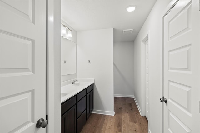 1505 Mirador Dr, Conroe, TX 77301 - bathroom with double vanity, wood finished floors, and baseboards