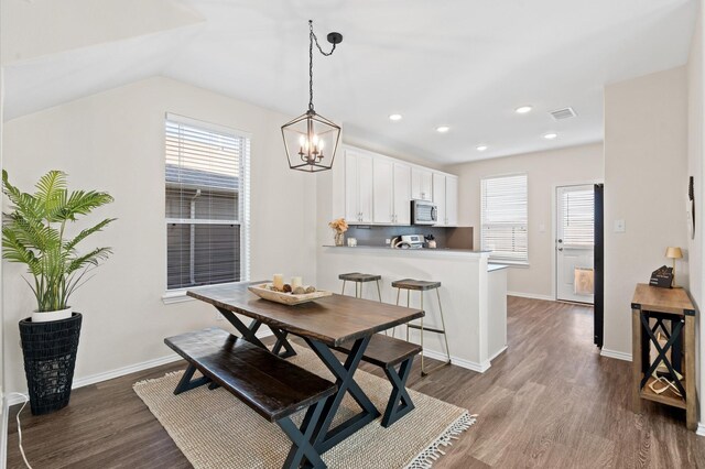 17810 Planted Orchard Dr, Hockley, TX 77447 - dining space with a chandelier, dark wood-type flooring, healthy amount of natural light, vaulted ceiling, and recessed lighting
