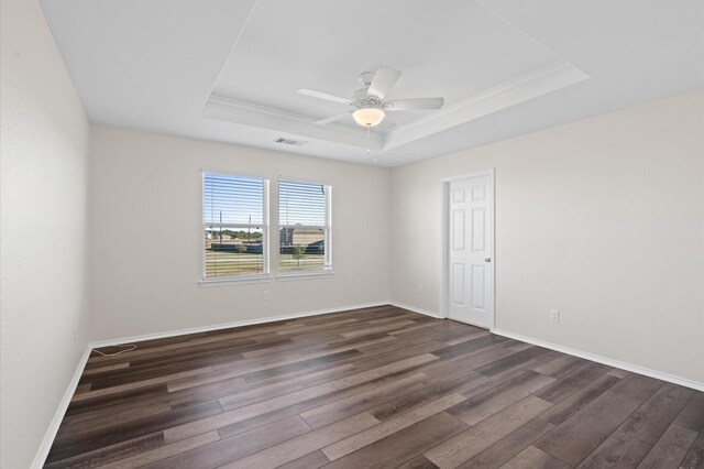 17810 Planted Orchard Dr, Hockley, TX 77447 - empty room with a raised ceiling, dark wood-type flooring, ceiling fan, baseboards, and ornamental molding