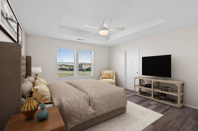 17810 Planted Orchard Dr, Hockley, TX 77447 - bedroom featuring a tray ceiling, wood finished floors, crown molding, ceiling fan, and baseboards