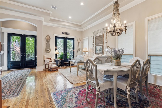 414 E 28th St, Houston, TX 77008 - dining space with french doors, wood finished floors, a chandelier, arched walkways, and baseboards