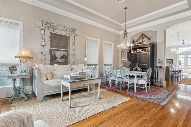 414 E 28th St, Houston, TX 77008 - living area featuring wood finished floors, a chandelier, crown molding, and a tray ceiling