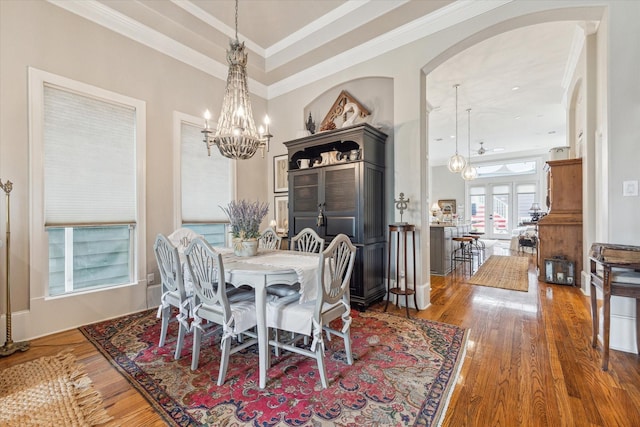 414 E 28th St, Houston, TX 77008 - dining area with a chandelier, wood finished floors, arched walkways, crown molding, and french doors