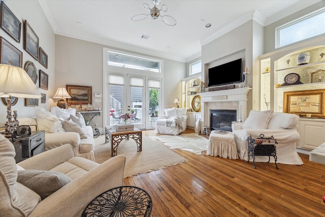 414 E 28th St, Houston, TX 77008 - living area with light wood-style flooring, a glass covered fireplace, crown molding, and a high ceiling