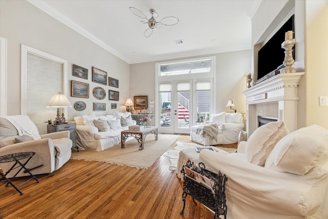 414 E 28th St, Houston, TX 77008 - living room with wood finished floors, crown molding, and a fireplace