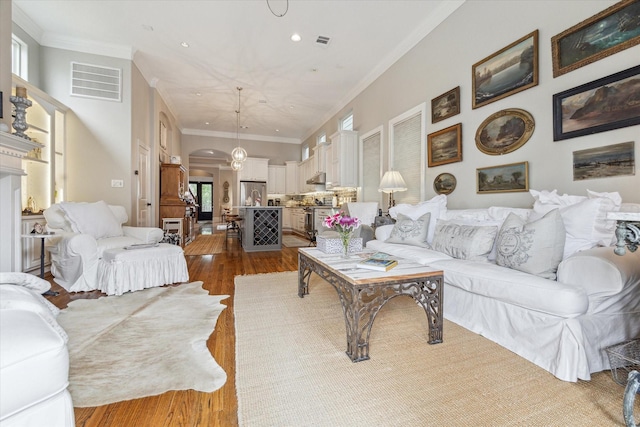 414 E 28th St, Houston, TX 77008 - living area with arched walkways, dark wood-style floors, recessed lighting, and crown molding