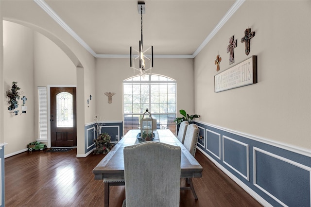 22734 Newcourt Place St, Tomball, TX 77375 - dining area with arched walkways, dark wood-style flooring, ornamental molding, and wainscoting