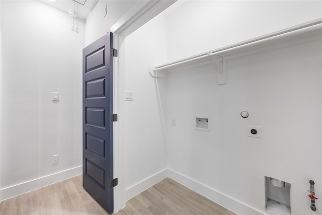 8221 Tower St, Houston, TX 77088 - laundry room with light wood-style floors, hookup for an electric dryer, hookup for a gas dryer, and baseboards