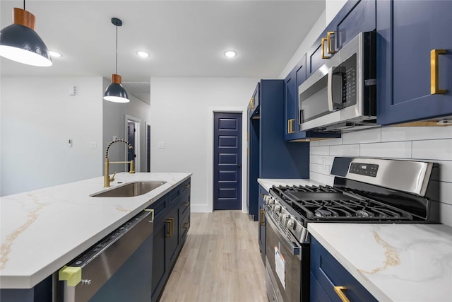 8221 Tower St, Houston, TX 77088 - kitchen featuring stainless steel appliances, a sink, blue cabinets, light wood-style flooring, and recessed lighting