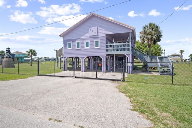 927 W Verdie Dr, Crystal Beach, TX 77650 - beach home featuring asphalt driveway, a gate, stairway, and a carport
