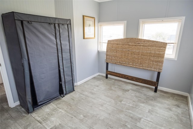 927 W Verdie Dr, Crystal Beach, TX 77650 - bedroom featuring wood finished floors, multiple windows, and baseboards