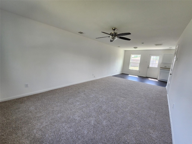 207 Branch Cir, Kendleton, TX 77451 - empty room featuring dark colored carpet, ceiling fan, and baseboards