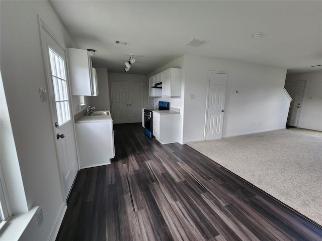 207 Branch Cir, Kendleton, TX 77451 - kitchen featuring range, a sink, light countertops, white cabinetry, and dark wood-style flooring