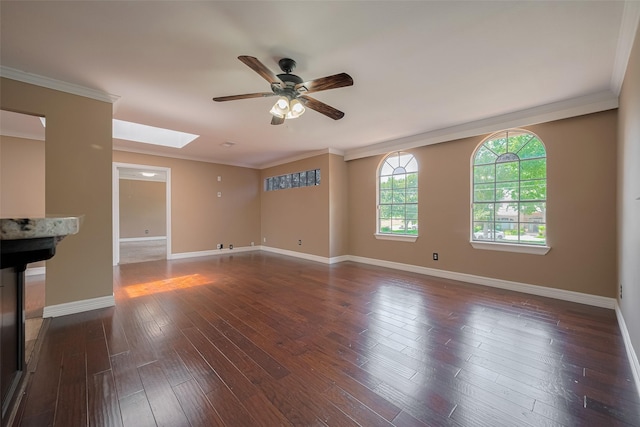 15509 Lakeview Dr, Jersey Village, TX 77040 - unfurnished living room featuring a skylight, ceiling fan, baseboards, crown molding, and dark wood-style floors