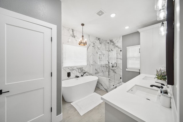 7332 Kurt Dr, Brenham, TX 77833 - full bathroom featuring a marble finish shower, a soaking tub, double vanity, recessed lighting, and a chandelier