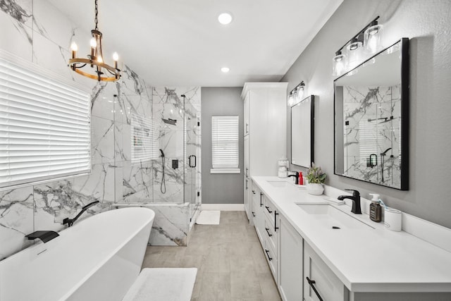 7332 Kurt Dr, Brenham, TX 77833 - full bathroom with a freestanding bath, a chandelier, double vanity, a marble finish shower, and recessed lighting