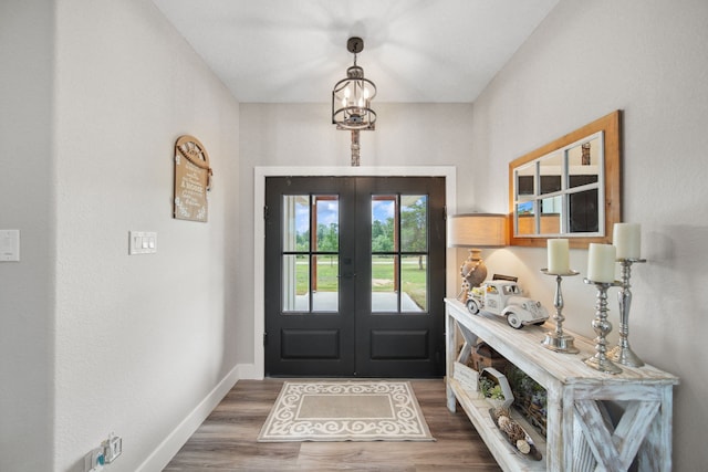 7332 Kurt Dr, Brenham, TX 77833 - entrance foyer featuring french doors, wood finished floors, and baseboards