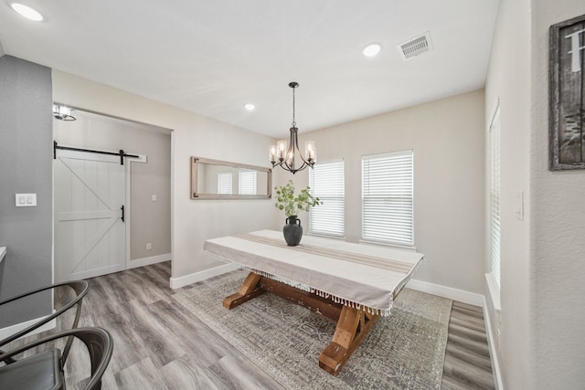 7332 Kurt Dr, Brenham, TX 77833 - dining room featuring a barn door, wood finished floors, baseboards, recessed lighting, and a chandelier