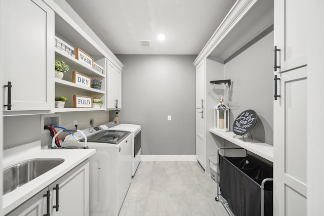 7332 Kurt Dr, Brenham, TX 77833 - washroom with cabinet space, separate washer and dryer, baseboards, and recessed lighting