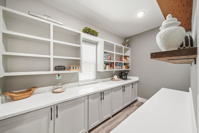 7332 Kurt Dr, Brenham, TX 77833 - kitchen with open shelves, light wood-style floors, light countertops, baseboards, and recessed lighting