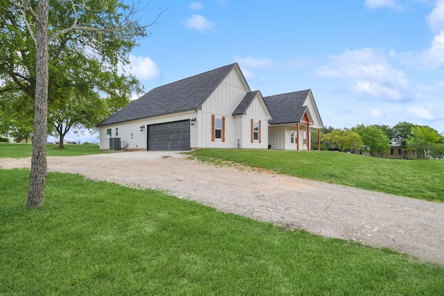 7332 Kurt Dr, Brenham, TX 77833 - view of side of property featuring driveway, board and batten siding, an attached garage, a lawn, and roof with shingles
