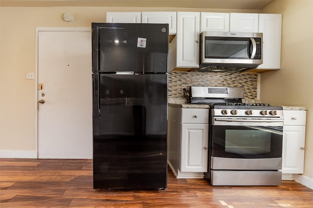 10601 Murr Way, Houston, TX 77048 - kitchen with appliances with stainless steel finishes, white cabinets, tasteful backsplash, and dark wood-style flooring