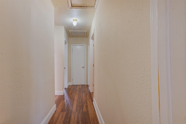 10601 Murr Way, Houston, TX 77048 - hallway with attic access, dark wood-style flooring, baseboards, and a textured wall