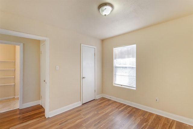 10601 Murr Way, Houston, TX 77048 - unfurnished bedroom with light wood-type flooring and baseboards